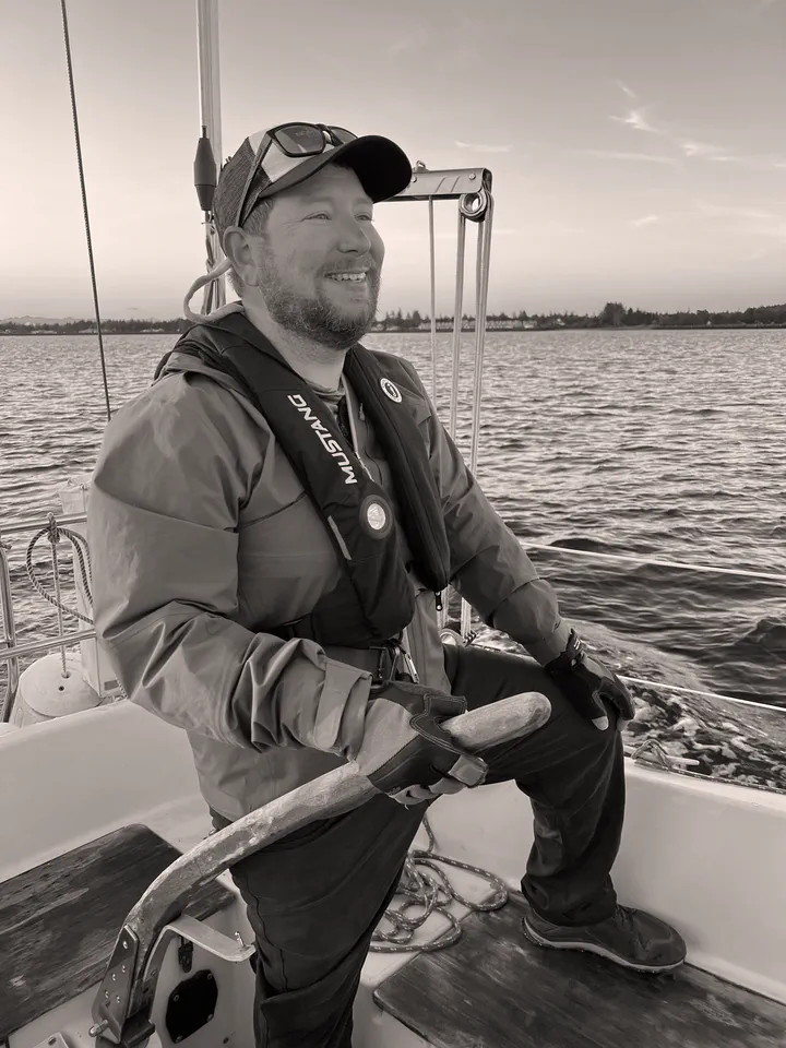 Andy Kipp at the tiller of a sailboat